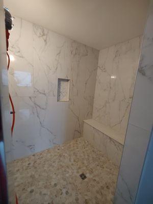 24x48  porcelain wall tile and river rock  shower floor tile