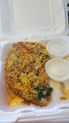 Great omelet.  Made to order, small (3 oz) or large (6 oz).  This is a large with ham, tomatoes, mushrooms, spinach, garlic, and cheese.