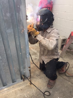 Joe Guerra repairing a door at Tejas car wash