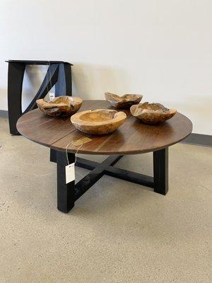 Acacia wood coffee table with metal base.