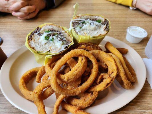 Philly cheesesteak sandwich with fresh made onion rings