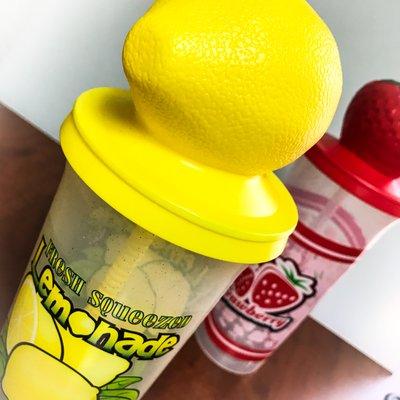 Souvenir lemonade and strawberry lemonade plastic cups.