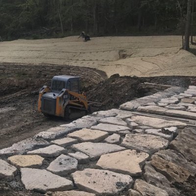 Installing a Erosion Control Matting, ECM with high end seed above a pond on a $17 million dollar house in Kansas City.