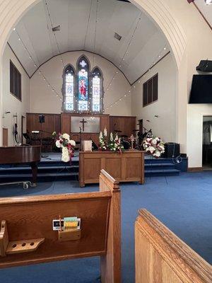 Arrangements setting together at front of church.