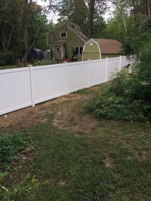 View from our yard looking at fence and neighbors yard