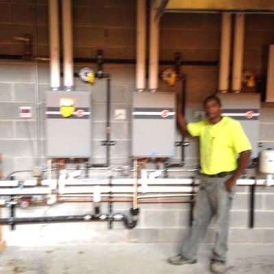 Dawson plumbing installing three Rheem commercial water heaters on a restaurant. Boti at the Ponce city market downtown Alanna