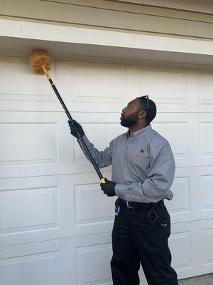 XTREME PEST SERVICES PERFORMING WEB SWEEP AROUND THE HOME.