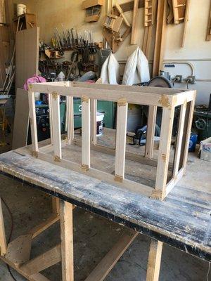 The frame of a chest for the foot of a bed.