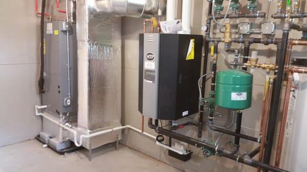 A full install on a hydronic unit and boiler  Heating and cooling hydronic unit with high efficiency boiler