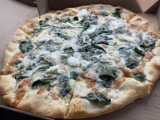 White pie with spinach, ricotta, mozzarella, and garlic