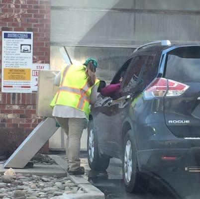 Cashier helping a customer pay for the car wash.