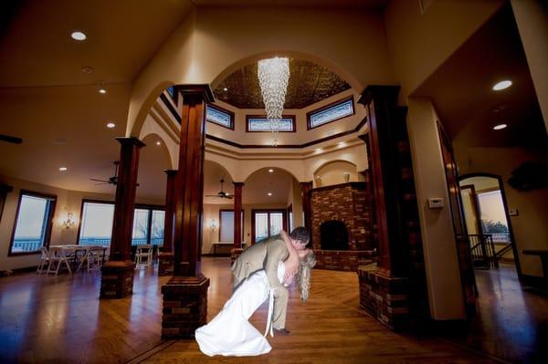 A distinctive gorgeous crystal chandelier surrounded by eight panels of stained/beveled glass adorn the great hall...