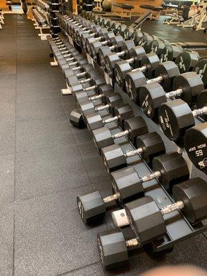 Full weight rack in the center of gym . Have these wall mirrors that "split" the gym in half