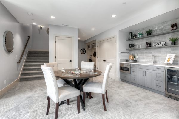 Downstairs entertainment area with Decor cabinets and matching floating shelves