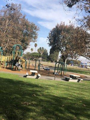 Benches, grills, trees, playground, grass