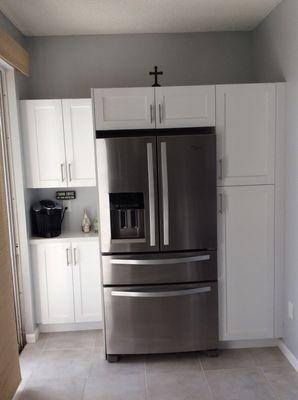 Cabinets built around fridge with different depths bcs of glass doors.