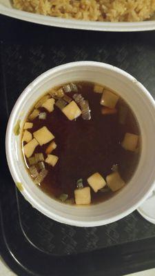 This is the brown water in a coffee cup with tiny cubes of mush tofu..called Miso!