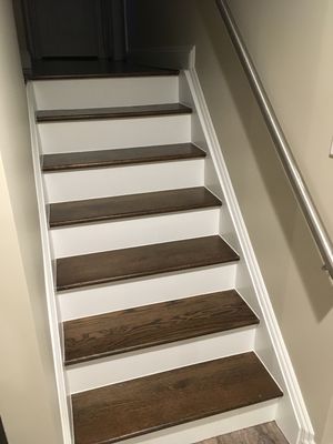 Wood stairs repaired and painted with Benjamin Moore white paint.