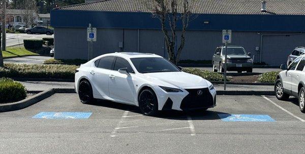 This car is parked in two disabled persons parking spots. This car carries no placard for this parking spot.