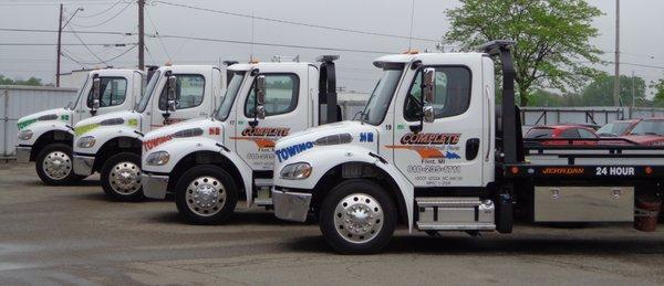 Four flatbed trucks ready to serve you.