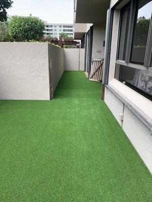 Artificial turf on top of a wooden deck.