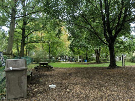 View toward Rutgers Ave, with another picnic table, trashcan, recycling, and little free library