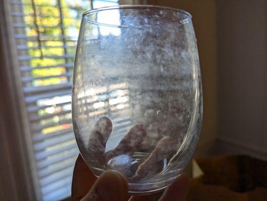 Dirty wine glass that was on the shelf.