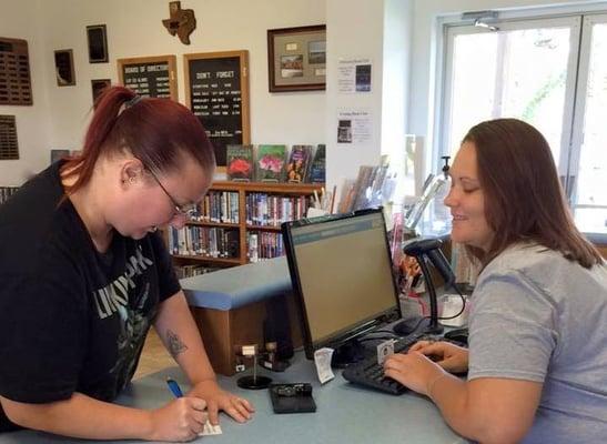 A new patron fills out a library card with the assistance of our librarian Melissa Brambila