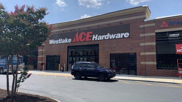 Front entrance to Westlake Ace Hardware in High Point, NC, with the customary car parked in the fire lane.