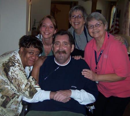 A resident celebrating his birthday at Malachi House with staff.  Proceeds from Krusty's help us care for those who need us most