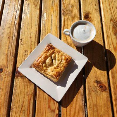 Latte and a puff pocket filled with ham and cheese.