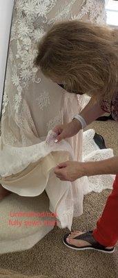 The seasoned seamstress who did the appraisal found a sheet of printer paper in the base of the gown...