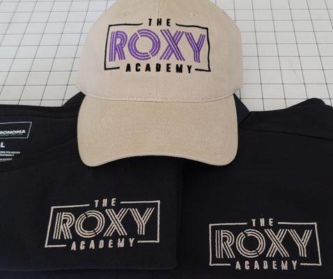 The Roxy Academy business logo embroidered on hat and shirts.