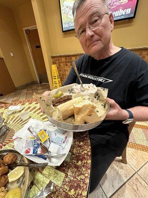 Hot sausage New Orleans style po'boy sandwich and creamy coleslaw.