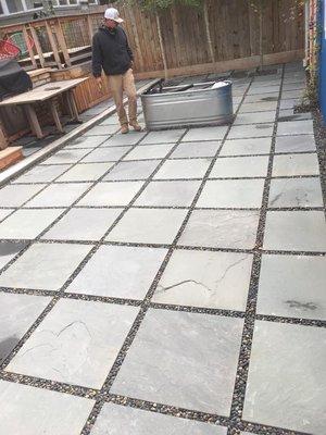 Flagstone stepping stones patio with pebble rock joints.