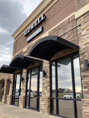 Front entrance on the side of the building. Located between Edward Jones and Heartland Grill.