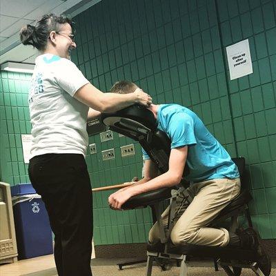 Cranial soothing chair massage at a community college event.