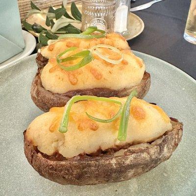 Potato skins filled with lamb, peas, carrots, and herbs. Topped with cheddar cheese.