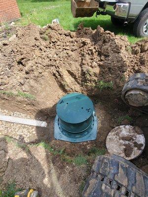 Installation of a riser on a septic tank.