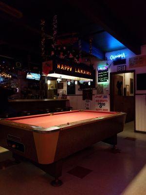 Happy Landing sign above pool table.