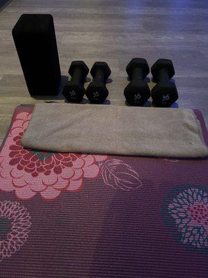 Ready for yoga. Blocks and weights provided by the studio for free. Bring your own mat and towel (you can also rent a mat for a fee)