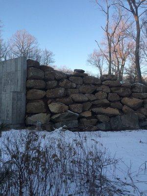 Stacked boulder retaining wall