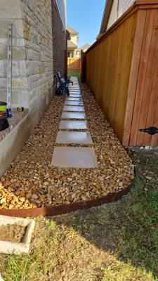 Riverrock/steping stones pathway with metal edging.