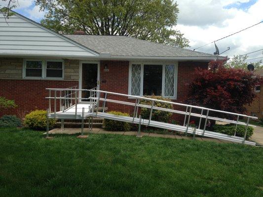 Modular aluminum ramp installed from drive to front door.