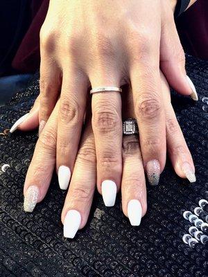 Acrylic Nails, coffin shape with white polish and sparkly accent nails.