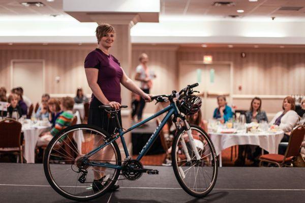 Showcasing fun and function for female cyclist at local fashion show. Model Kelly A.