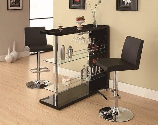 Black lacquer and glass bar with wine glass holders and adjustable swivel stools.