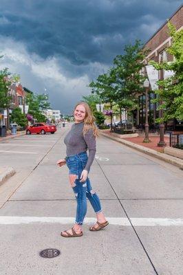 A high-school senior poses in downtown Wausau just before a storm rolls in.