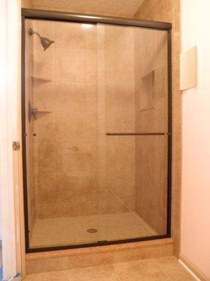 A custom semi-frameless bypass shower enclosure.