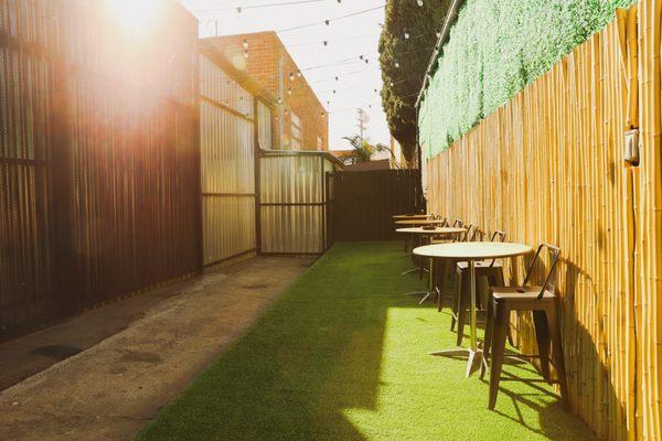 Outside patio with high top tables and chairs.